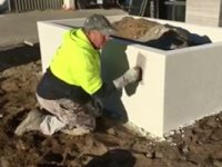 Worker applying texture coatings