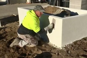 Worker applying texture coatings