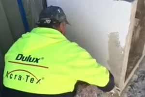 Worker applying texture coating